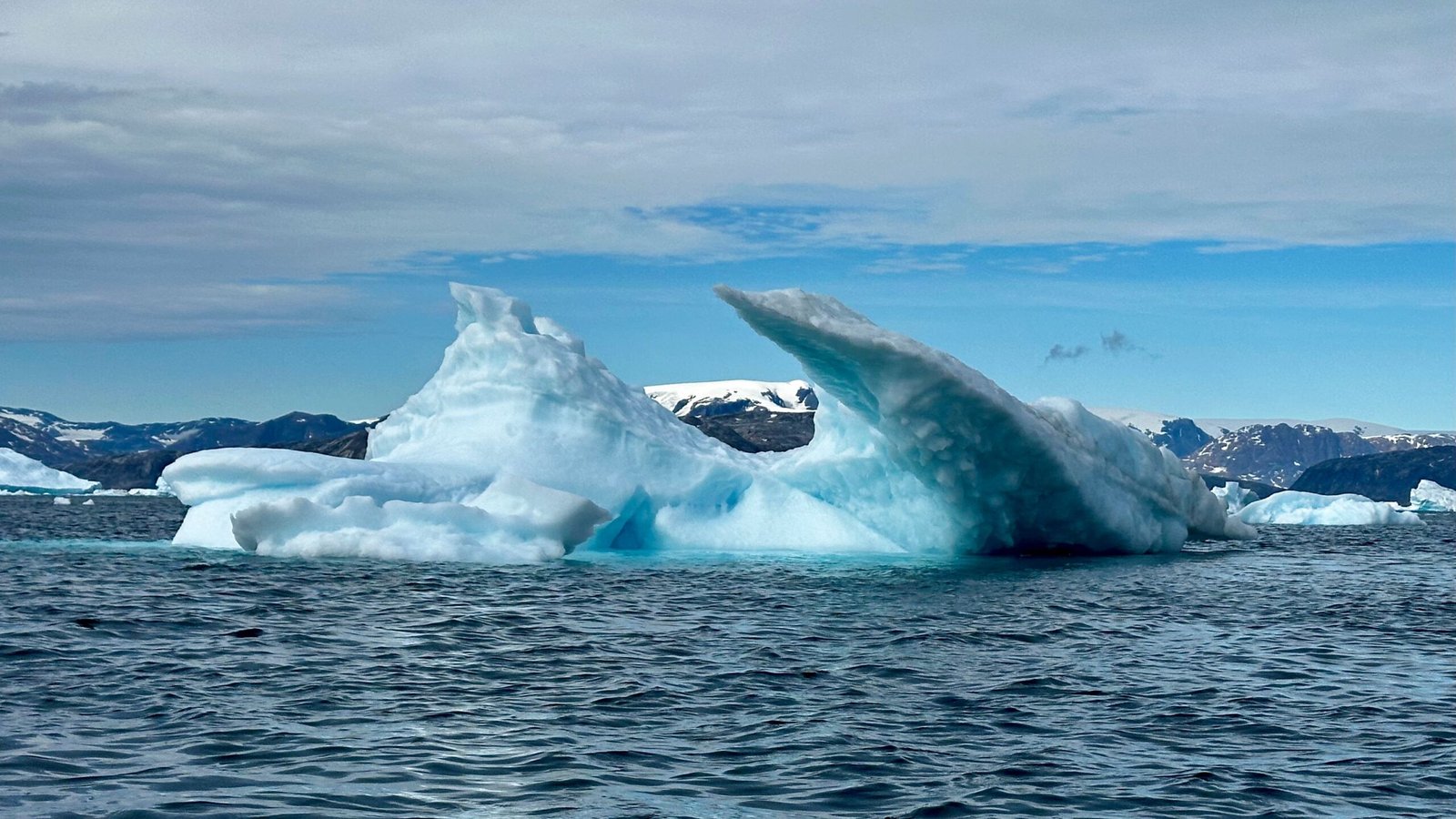 Iceberg floating in the ocean during daytime